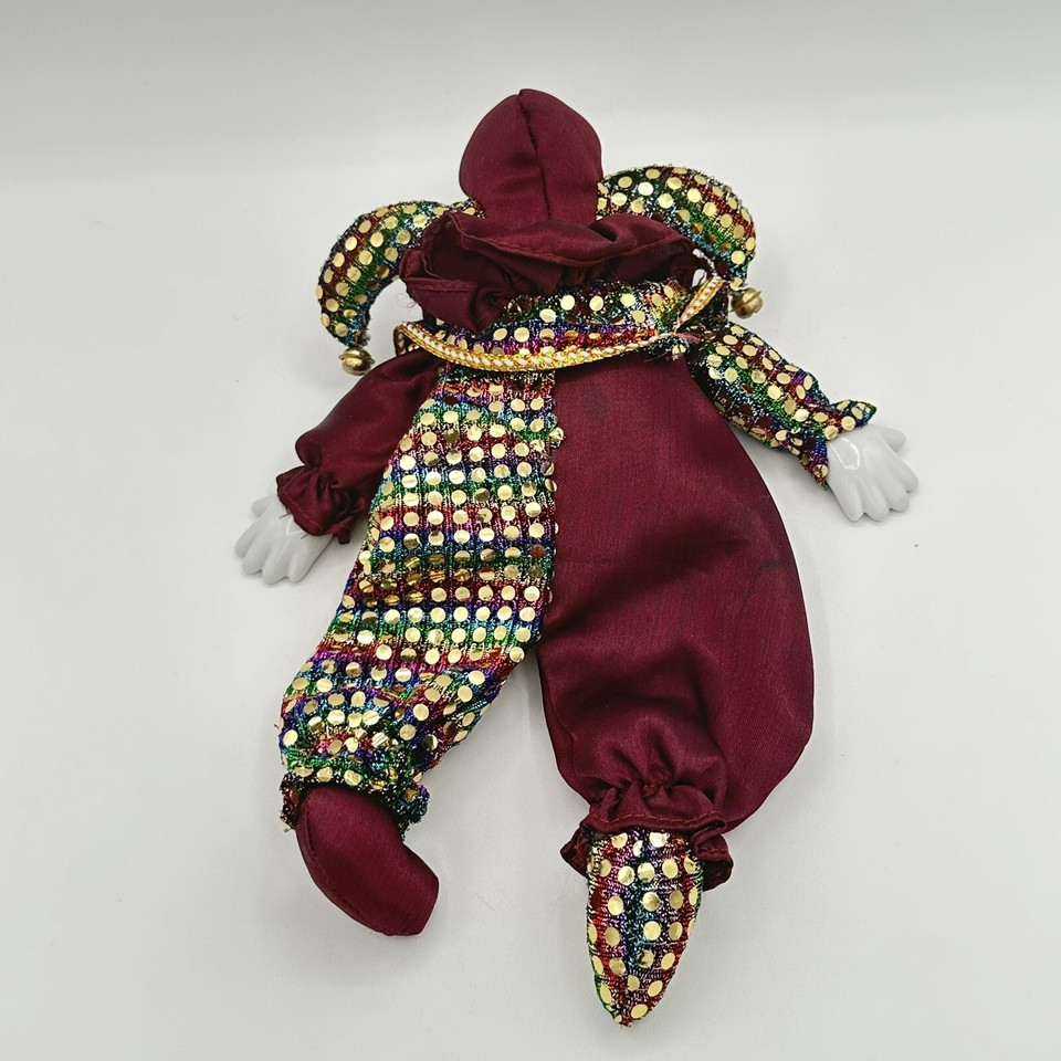 a porcelain-faced softbody clown lies facedown