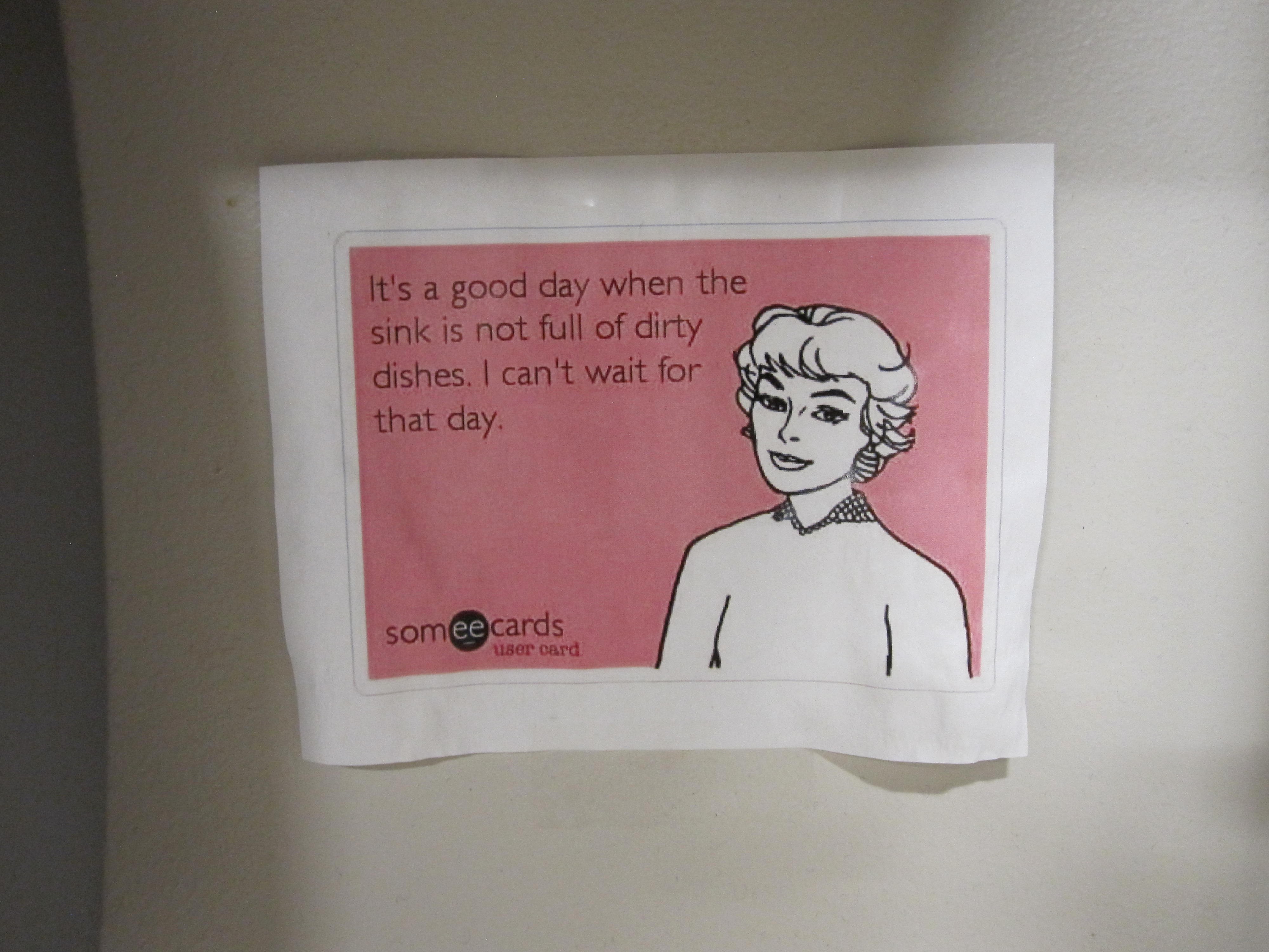 picture of a sign with a fifties housewife saying the dishes aren't self cleaning