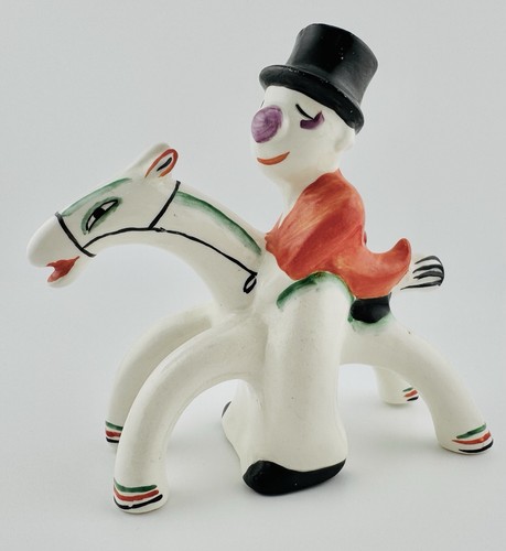 a porcelain clown on a stylized horse