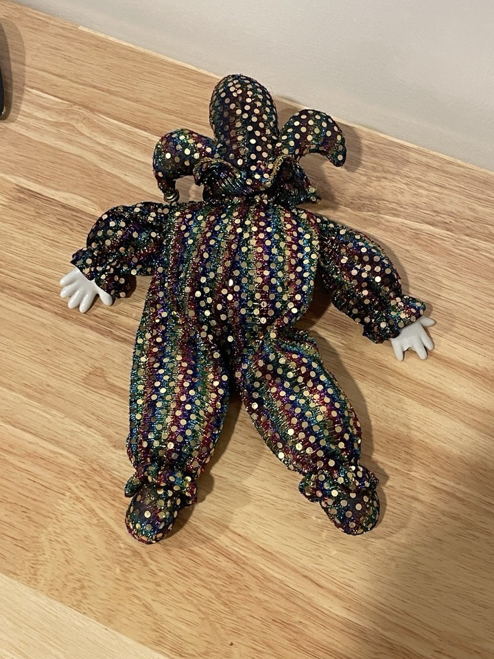 a porcelain faced softbody jester facedown on a floor