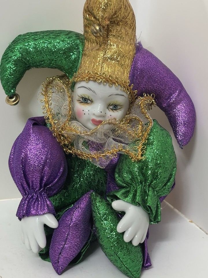 a slouched jester doll looking sleep deprived and depressed