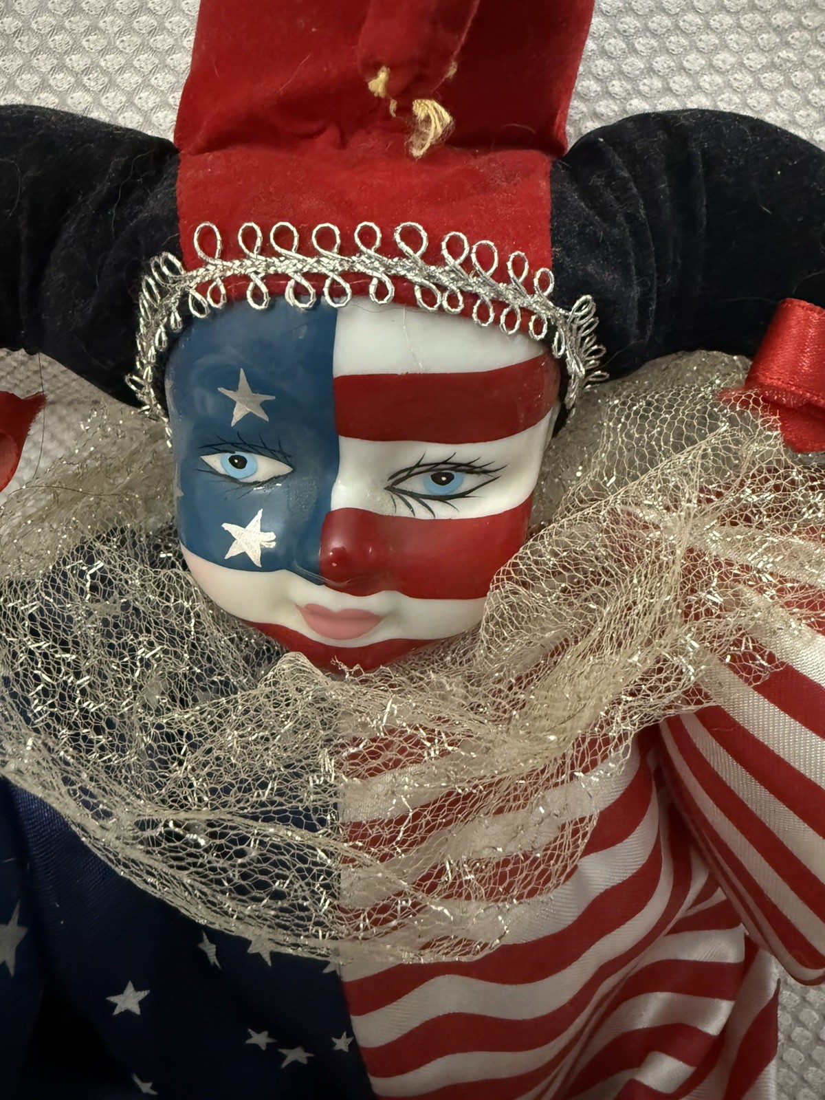 a star spangled clown with haunting blue eyes