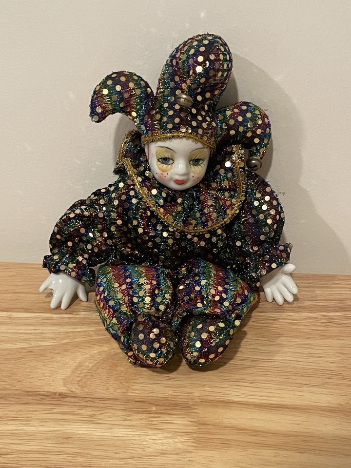 a glittery porcelain faced softbody jester