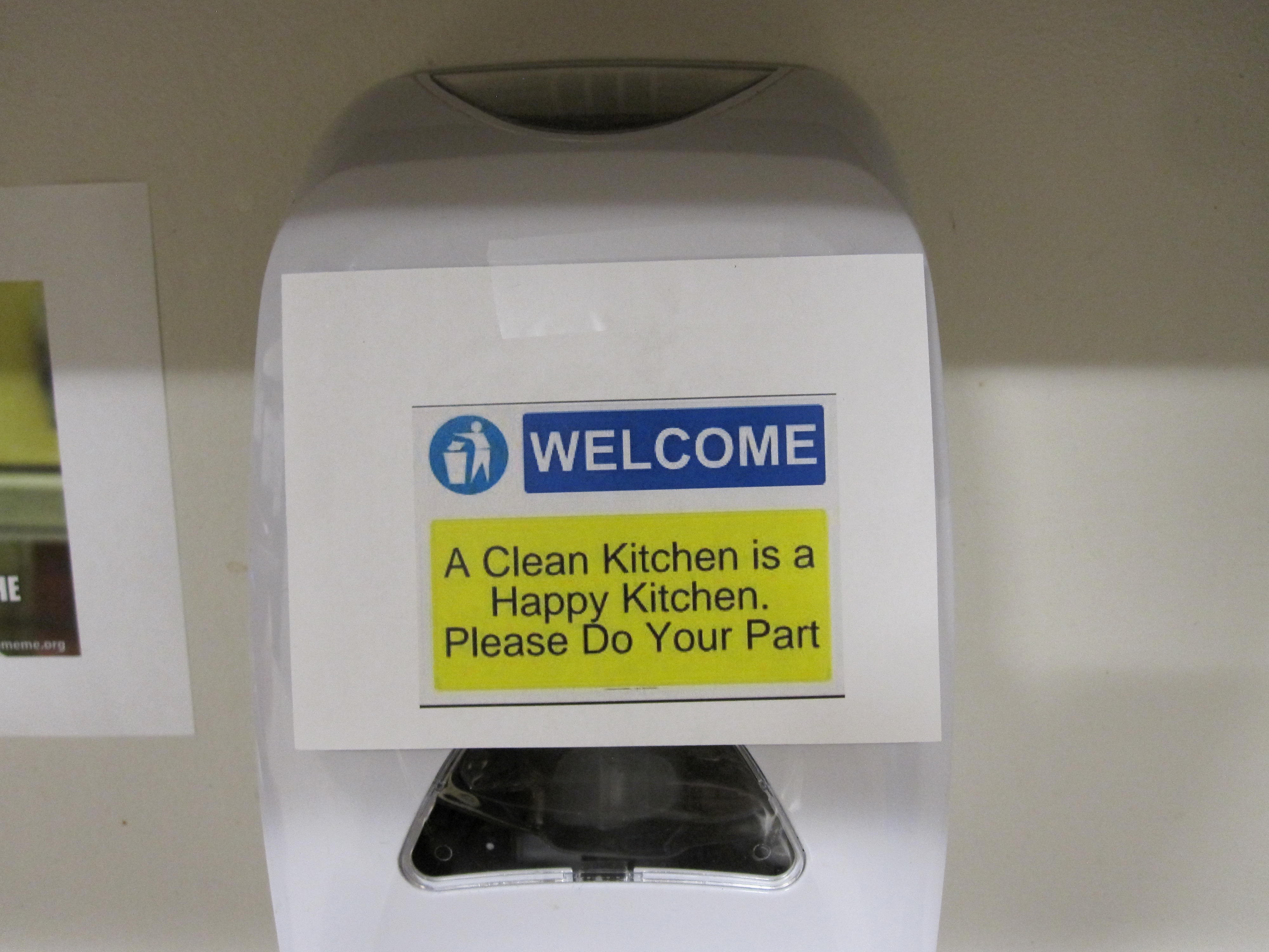 a passive aggressive sign encouraging viewers to clean up, taped to a soap dispenser