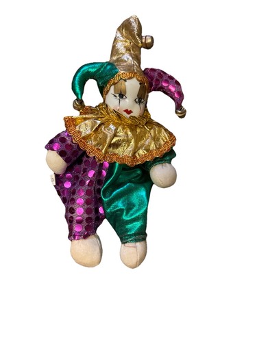 a porcelain faced clown with an expression belying some mischievous intent