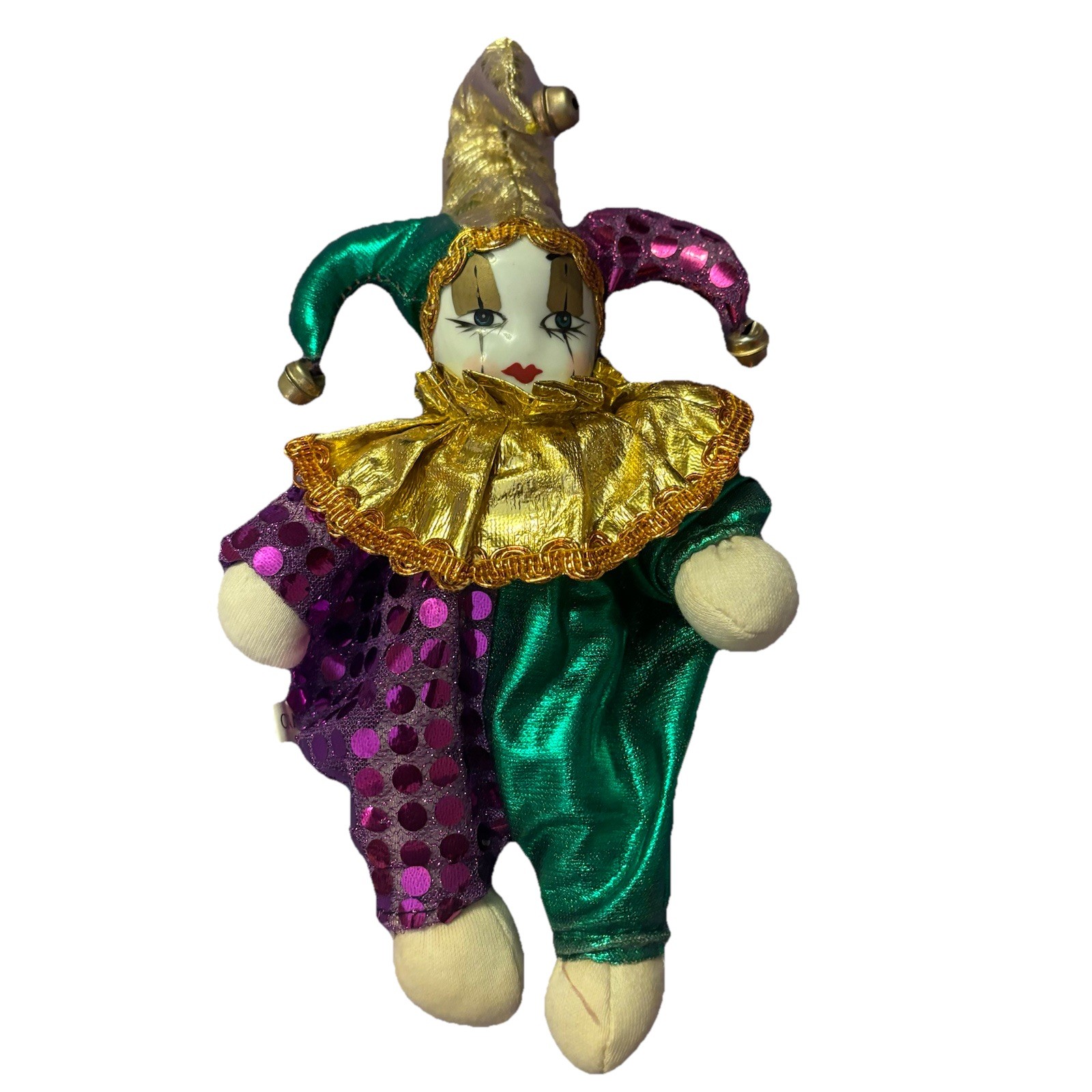 a porcelain faced clown with an expression belying some mischievous intent