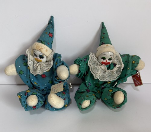 two porcelain faced softbody clowns sit next to each other