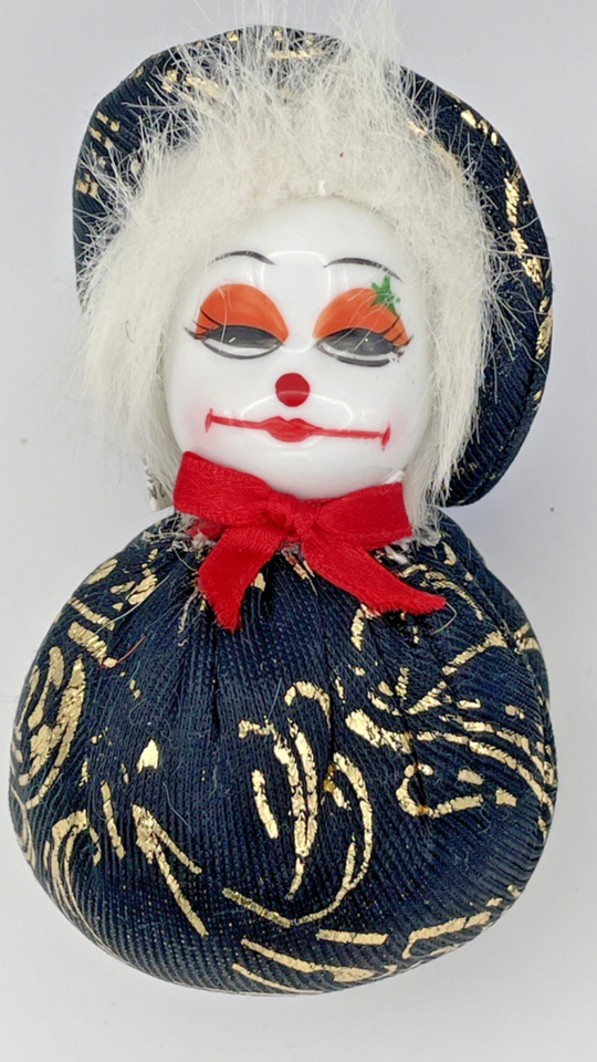 image of a smug looking porcelain-faced softbody clown