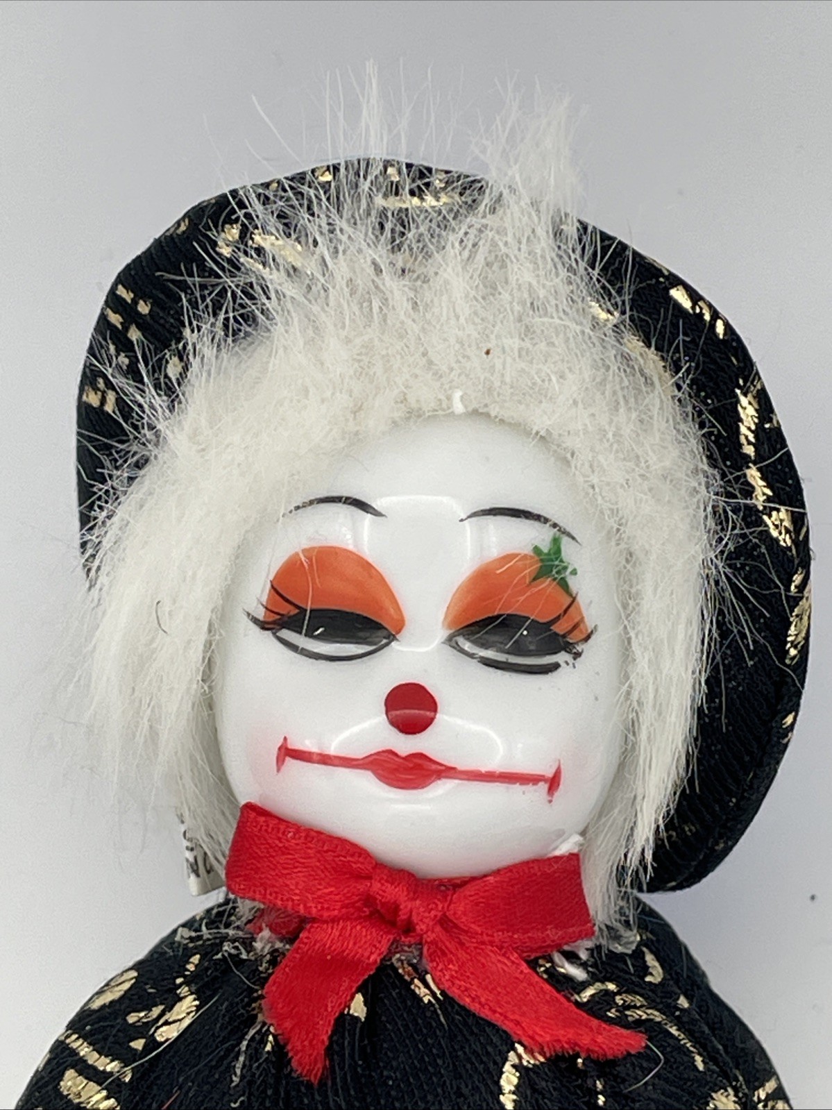 image of a smug looking porcelain-faced softbody clown