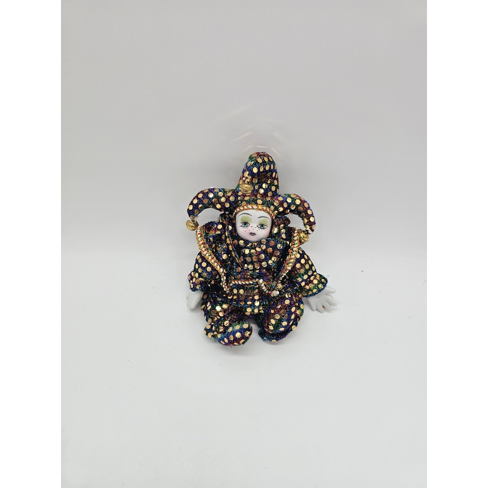 a sparkly porcelain-faced jester with big hands