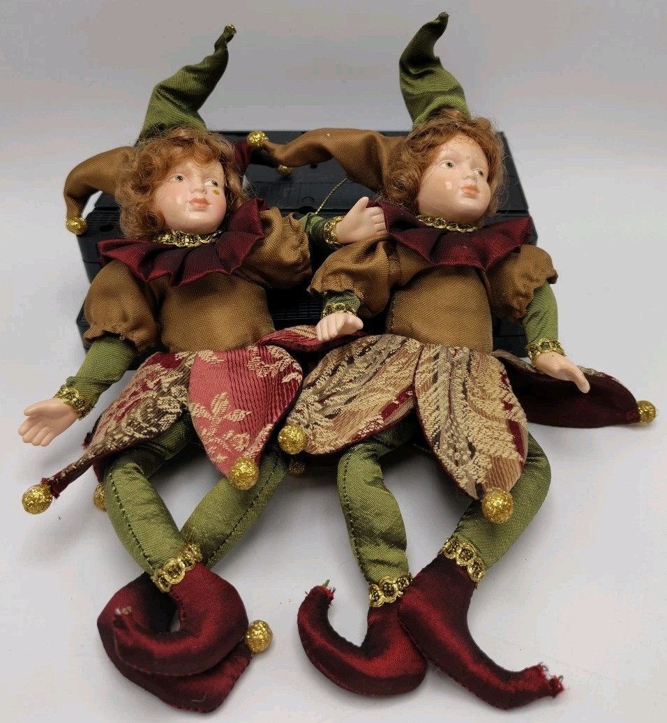 two nearly-identical looking clowns sit side by side